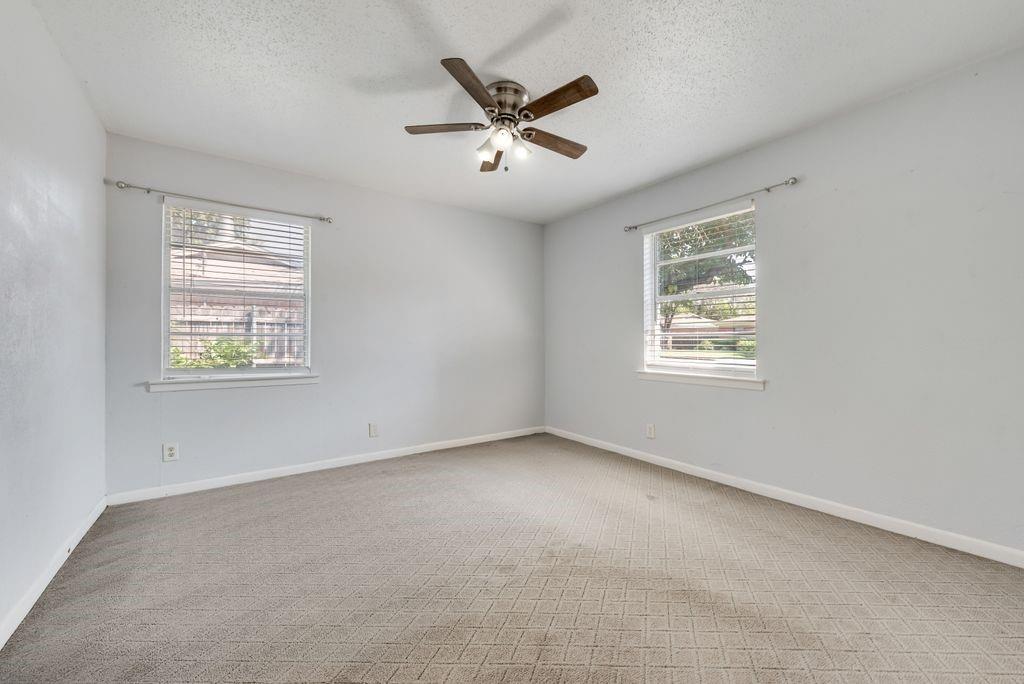 5201 Santa Rosa Drive Haltom City, TX 76117 - Photo 15 of 25 an empty room with ceiling fan and windows