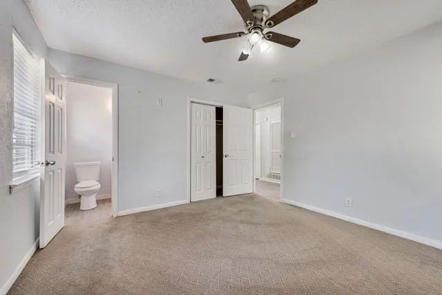 a view of an empty room with a bathroom