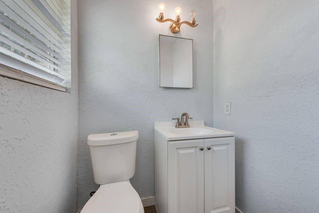 5201 Santa Rosa Drive Haltom City, TX 76117 - Photo 20 of 25 a bathroom with a toilet a sink and mirror