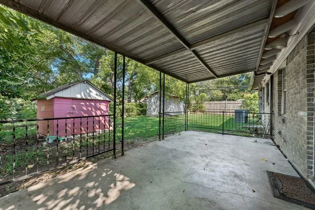 a view of a backyard with wooden fence