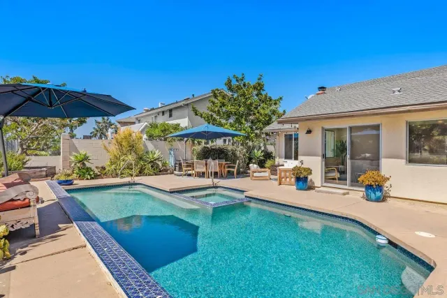 a view of a swimming pool with chairs in patio