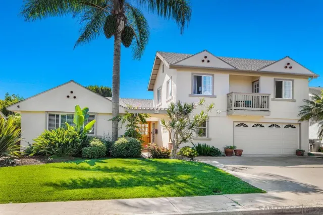 a front view of a house with a garden and a yard