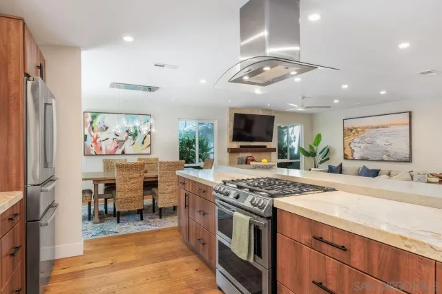 a view of kitchen with microwave stove dining table and chairs