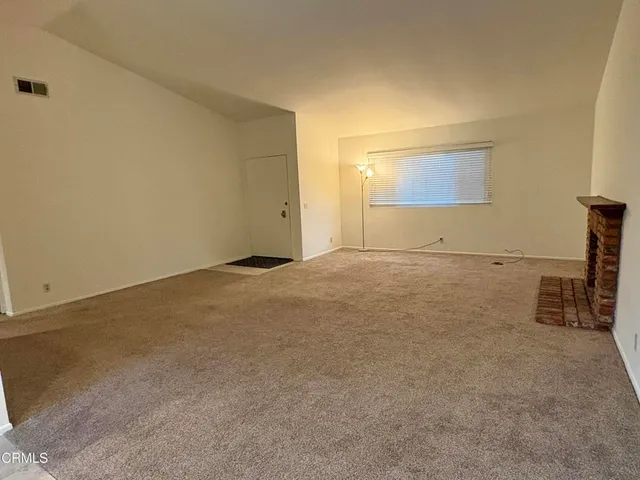 an empty room with a fireplace