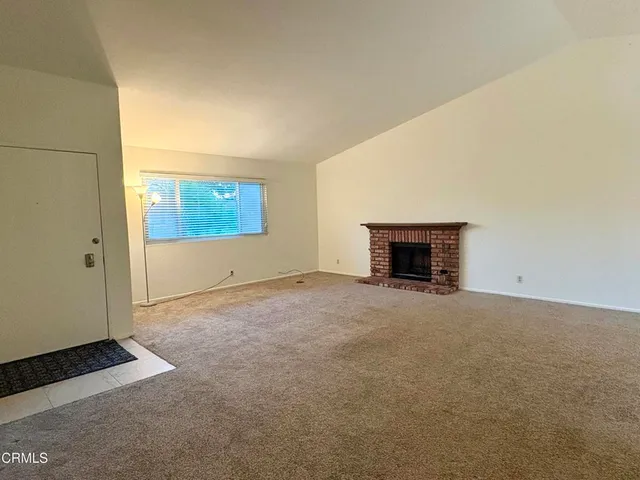 an empty room with a fireplace