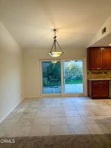 a large kitchen with granite countertop a stove top oven and refrigerator