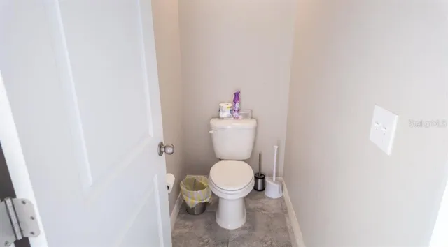 a white toilet sitting in a bathroom and a sink