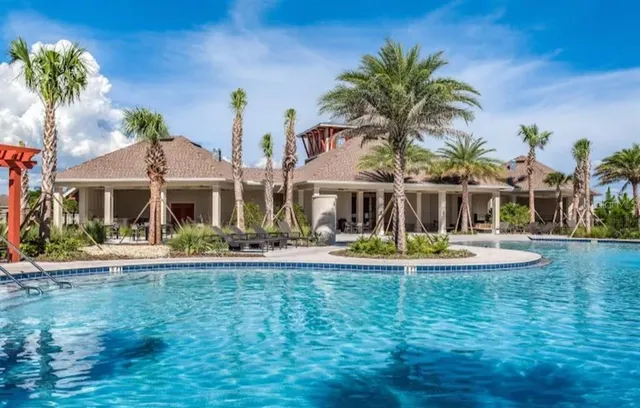 a front view of house with yard and swimming pool