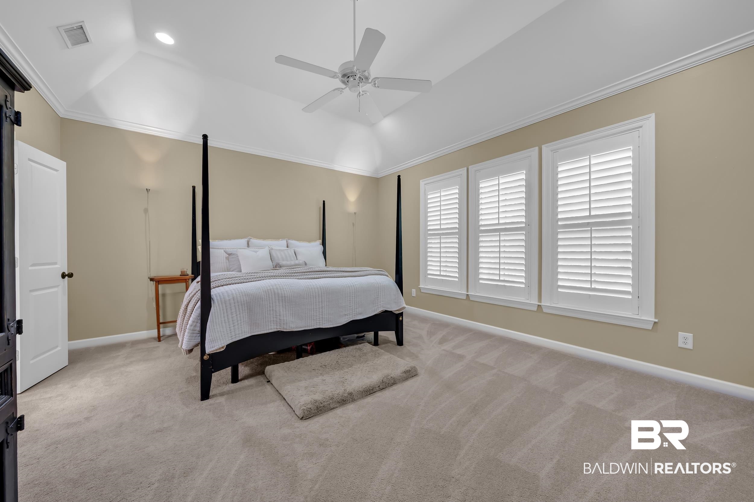 8137 Pine Run Daphne, AL 36527 - Photo 23 of 67 Carpeted room featuring a vaulted ceiling, three windows with plantation shutters, a ceiling fan, and recessed lighting