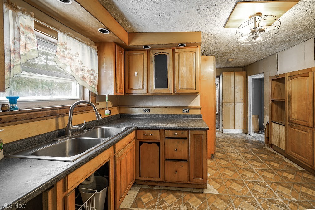9606 Durst Colebrook Road North Bloomfield, OH 44450 - Photo 2 of 24 Kitchen featuring sink, a textured ceiling, and dark tile floors