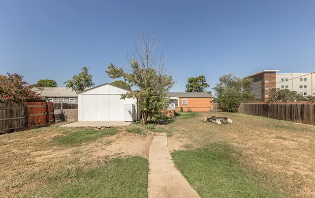 a view of a house with a yard and a garage