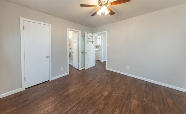 a view of an empty room with wooden floor