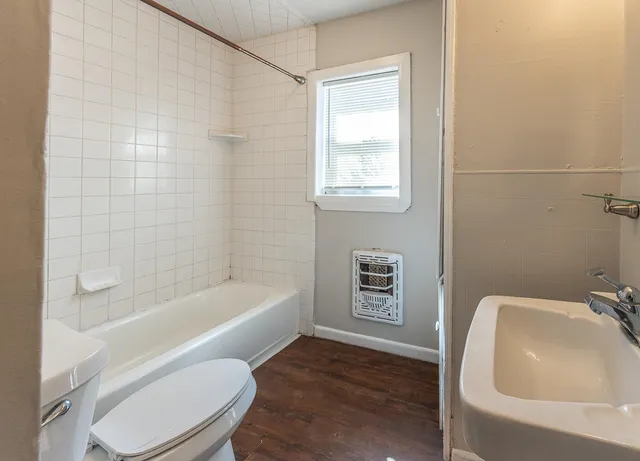 a bathroom with a toilet a sink and bathtub