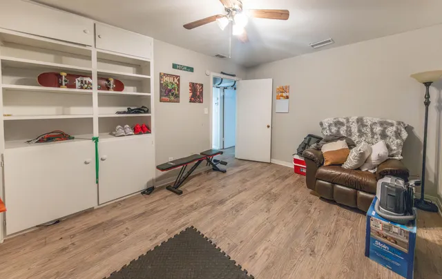 a bedroom with furniture and a wooden floor