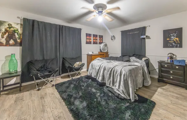 a bed room with a bed and a chair