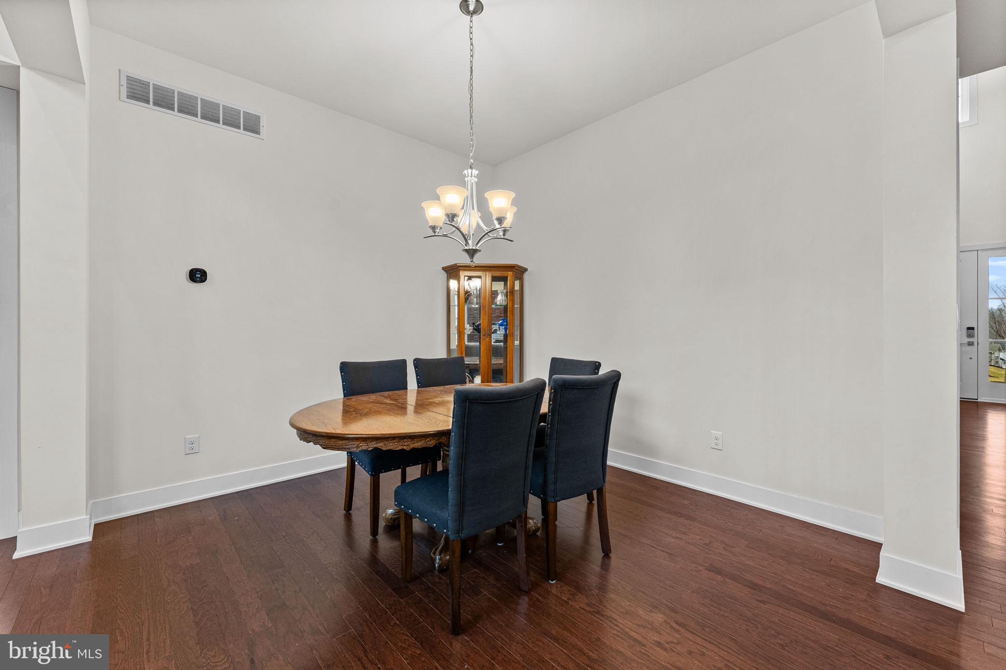 735 Appaloosa Road Downingtown, PA 19335 - Photo 11 of 35 a dining room with furniture a chandelier and wooden floor