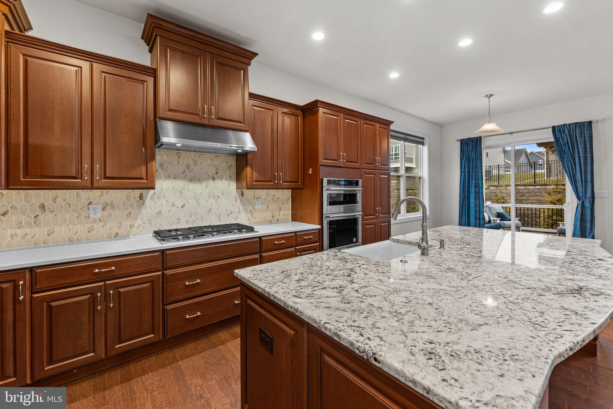 735 Appaloosa Road Downingtown, PA 19335 - Photo 18 of 35 a kitchen with stainless steel appliances granite countertop a stove refrigerator sink and cabinets