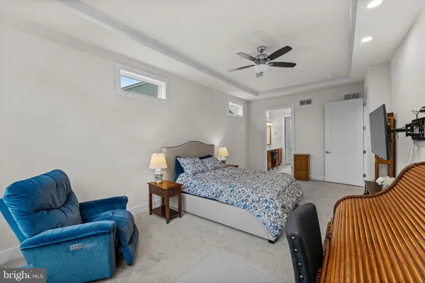 a bedroom with furniture and a ceiling fan
