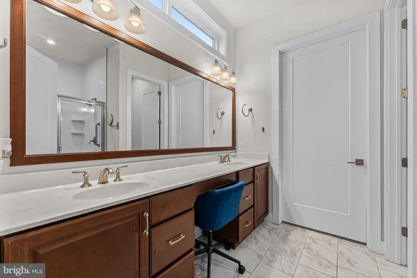 a bathroom with a double vanity sink and a mirror