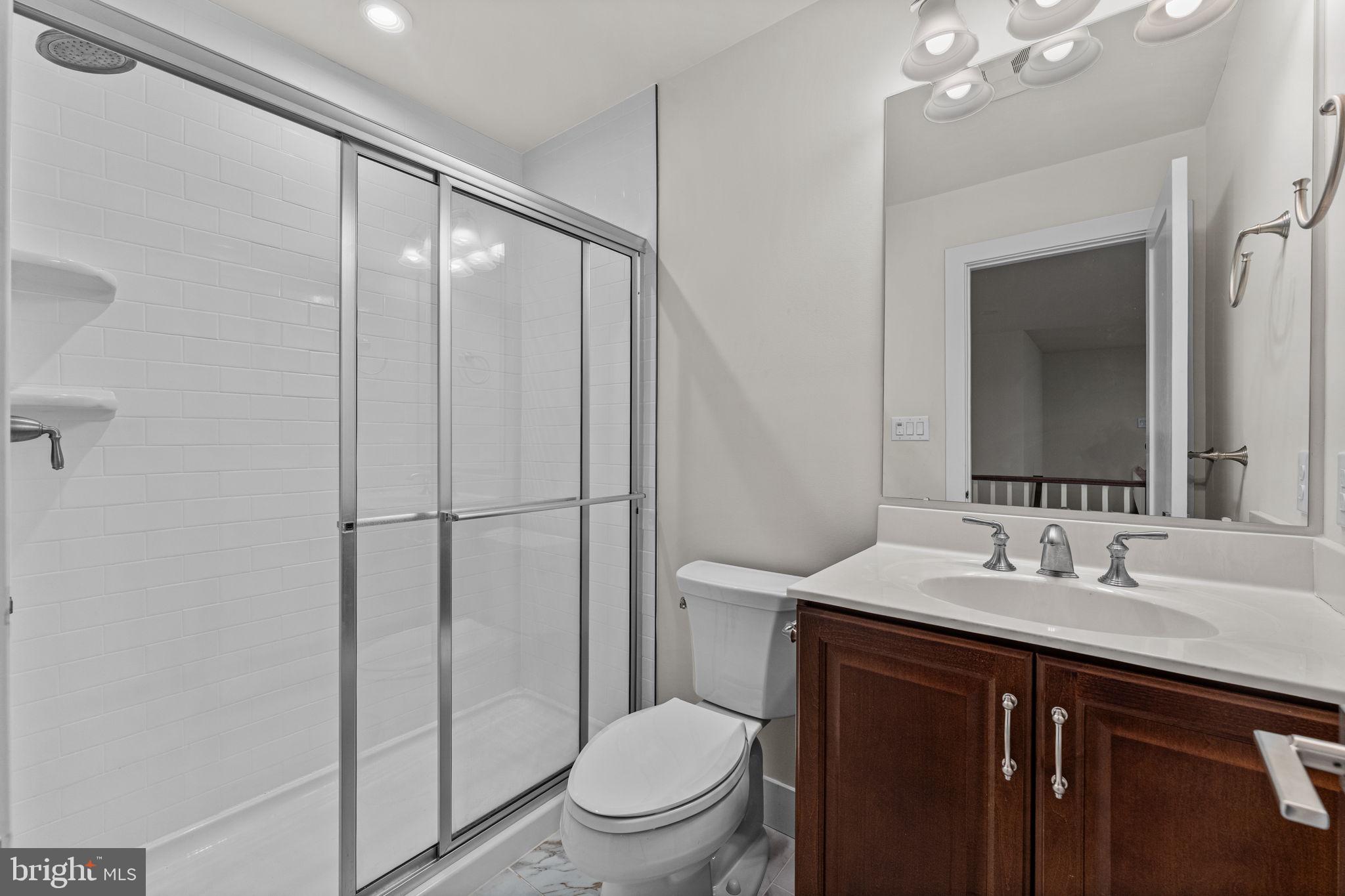 735 Appaloosa Road Downingtown, PA 19335 - Photo 28 of 35 a bathroom with a sink a toilet a mirror and shower