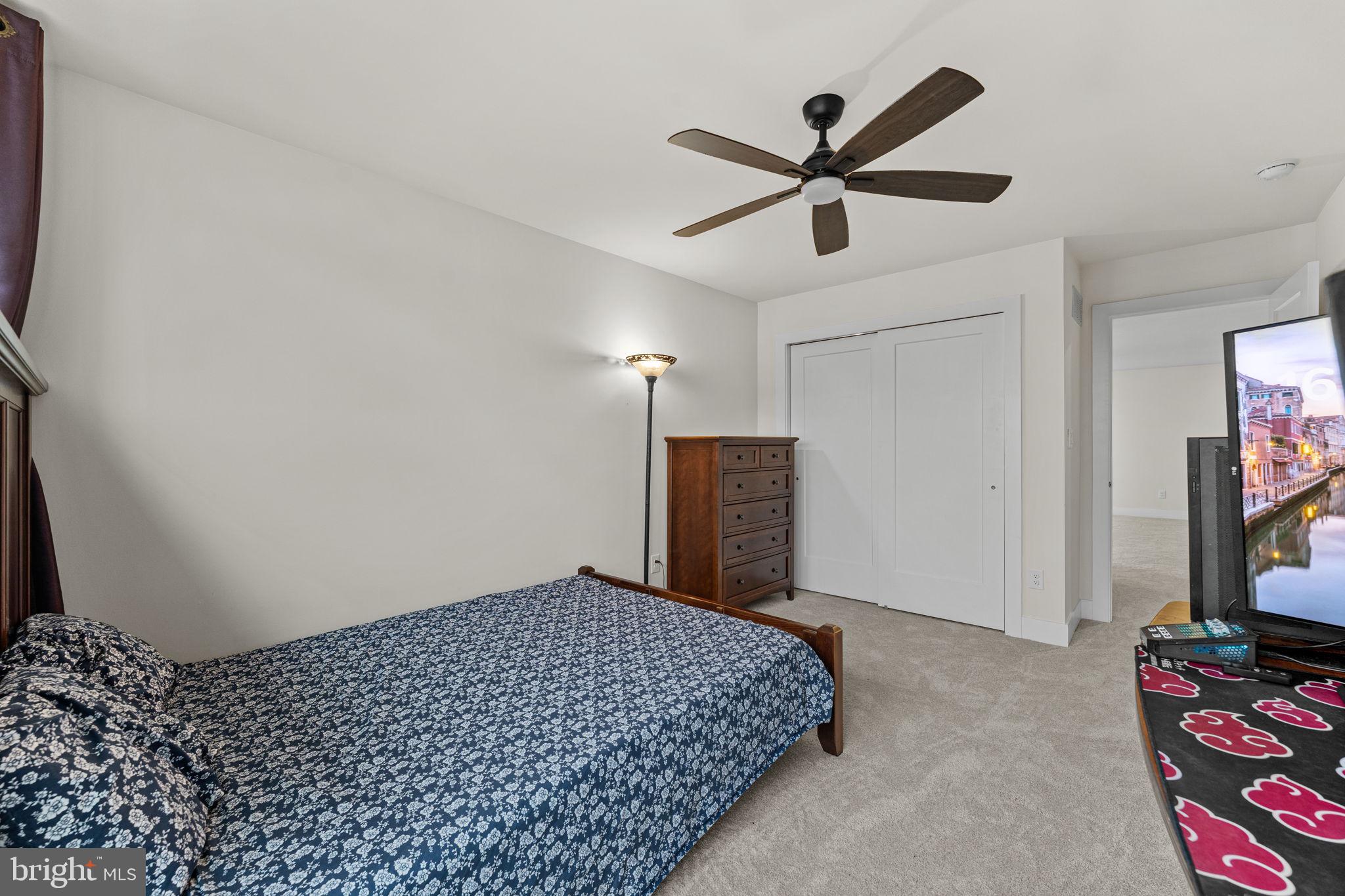 735 Appaloosa Road Downingtown, PA 19335 - Photo 30 of 35 a bedroom with a bed and a chandelier