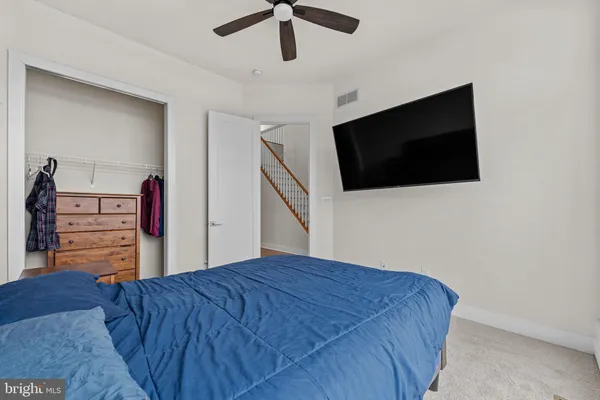a bedroom with a bed and a television