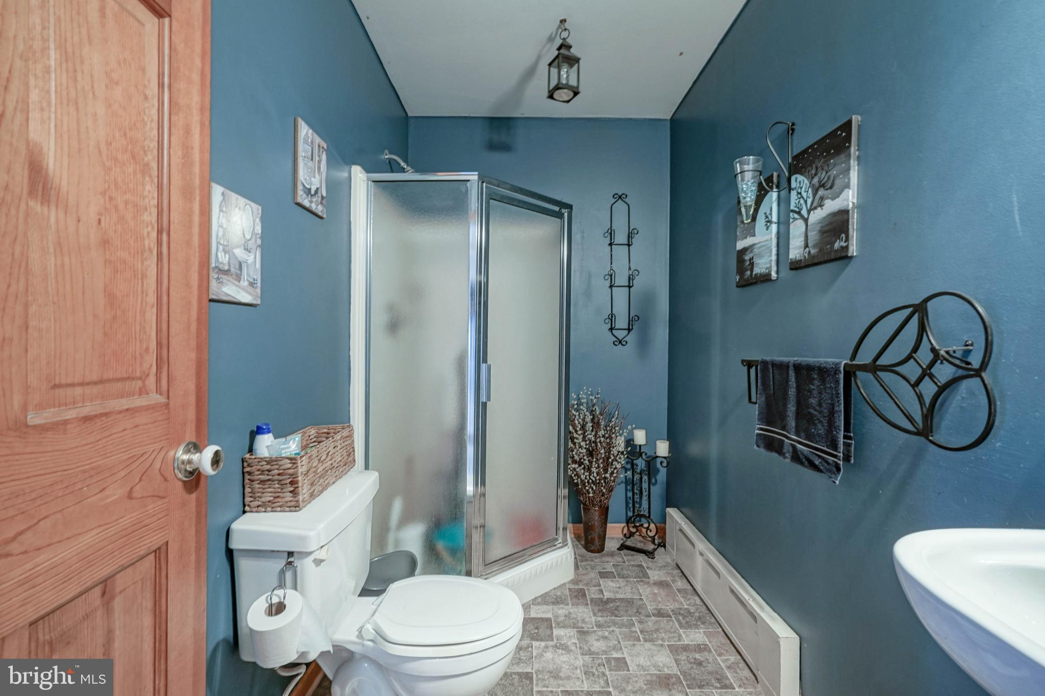 218 Walnut Street Audubon, NJ 08106 - Photo 20 of 40 a bathroom with a toilet a sink and shower