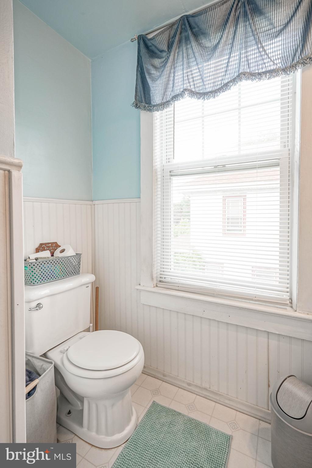 218 Walnut Street Audubon, NJ 08106 - Photo 22 of 40 a bathroom with a toilet a sink and a window