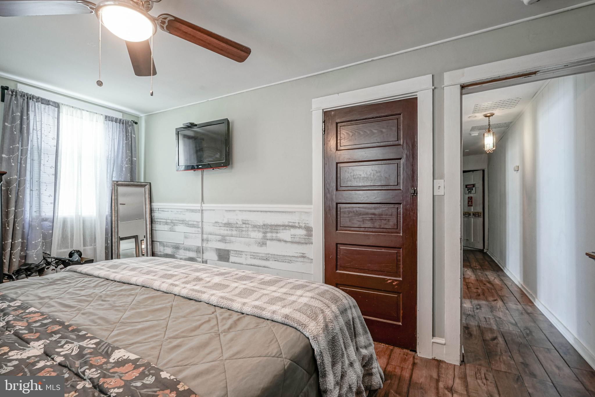 218 Walnut Street Audubon, NJ 08106 - Photo 26 of 40 a bedroom with a bed and a flat tv screen