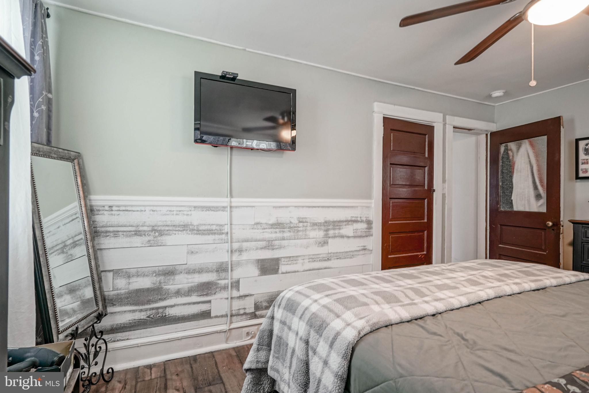 218 Walnut Street Audubon, NJ 08106 - Photo 27 of 40 a bedroom with a bed and a flat screen tv