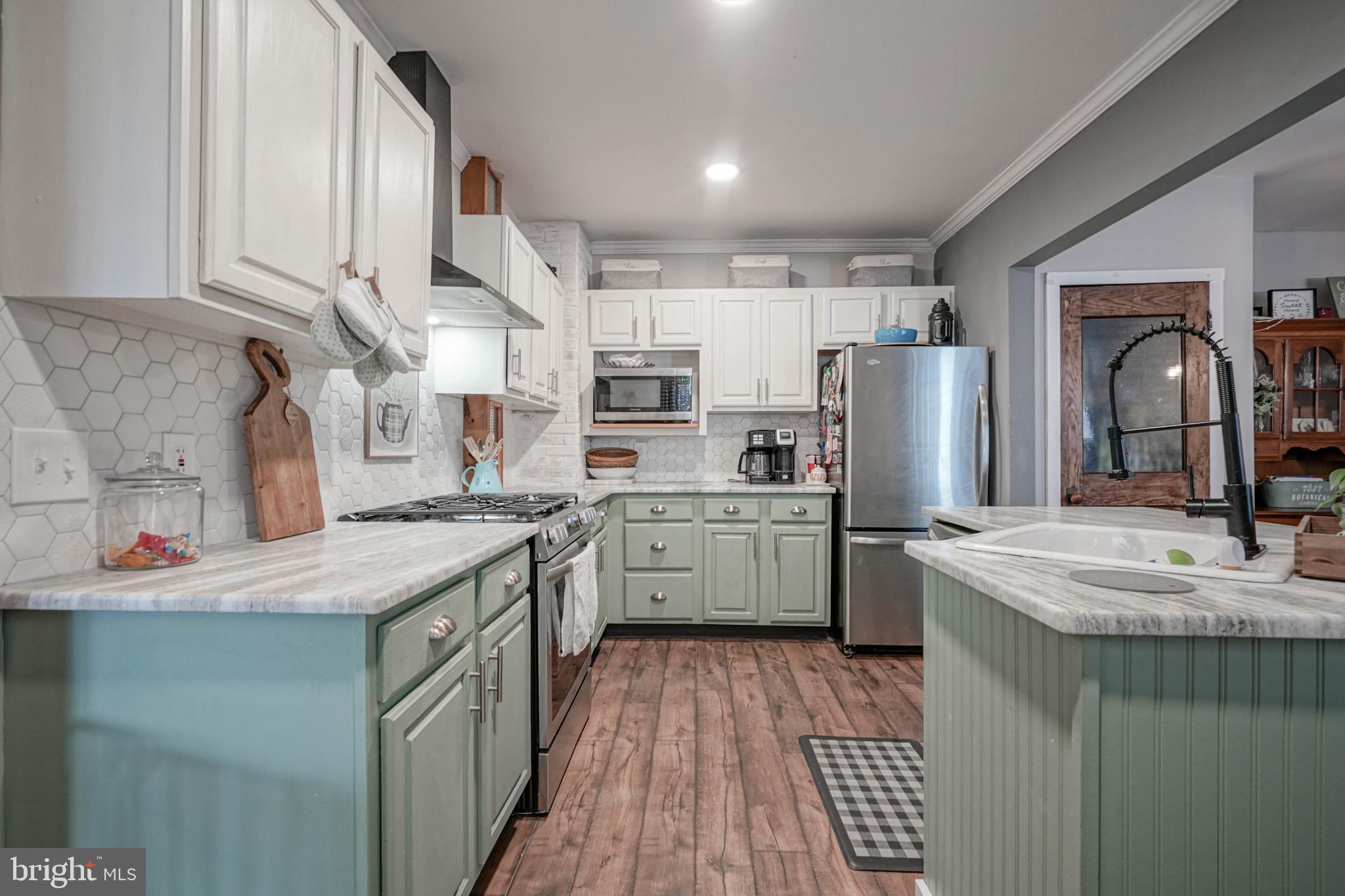 218 Walnut Street Audubon, NJ 08106 - Photo 3 of 40 a kitchen with a sink a refrigerator and cabinets