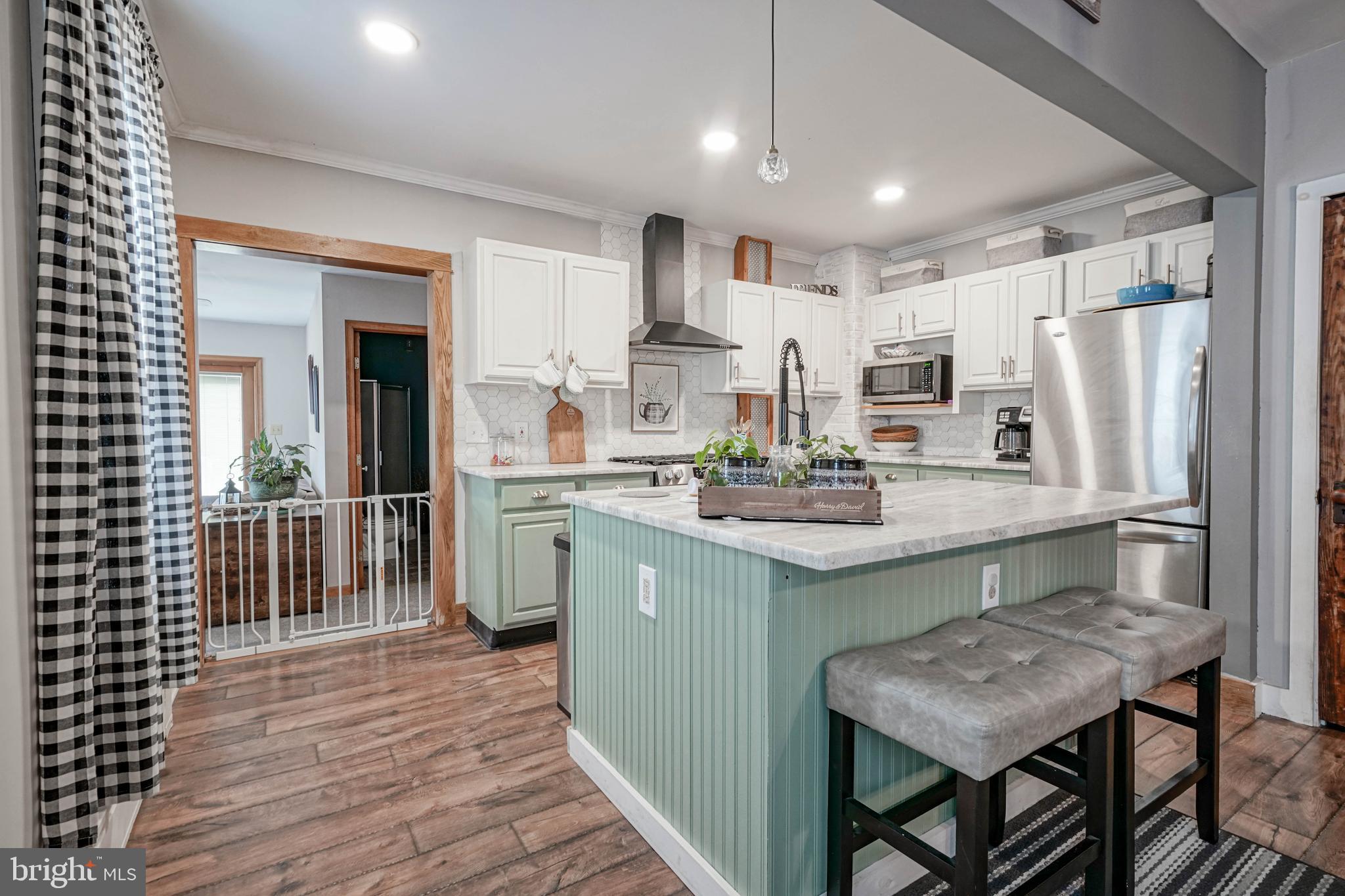 218 Walnut Street Audubon, NJ 08106 - Photo 7 of 40 a kitchen with kitchen island a sink table and chairs