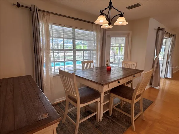 a view of a dining room with furniture window and wooden floor