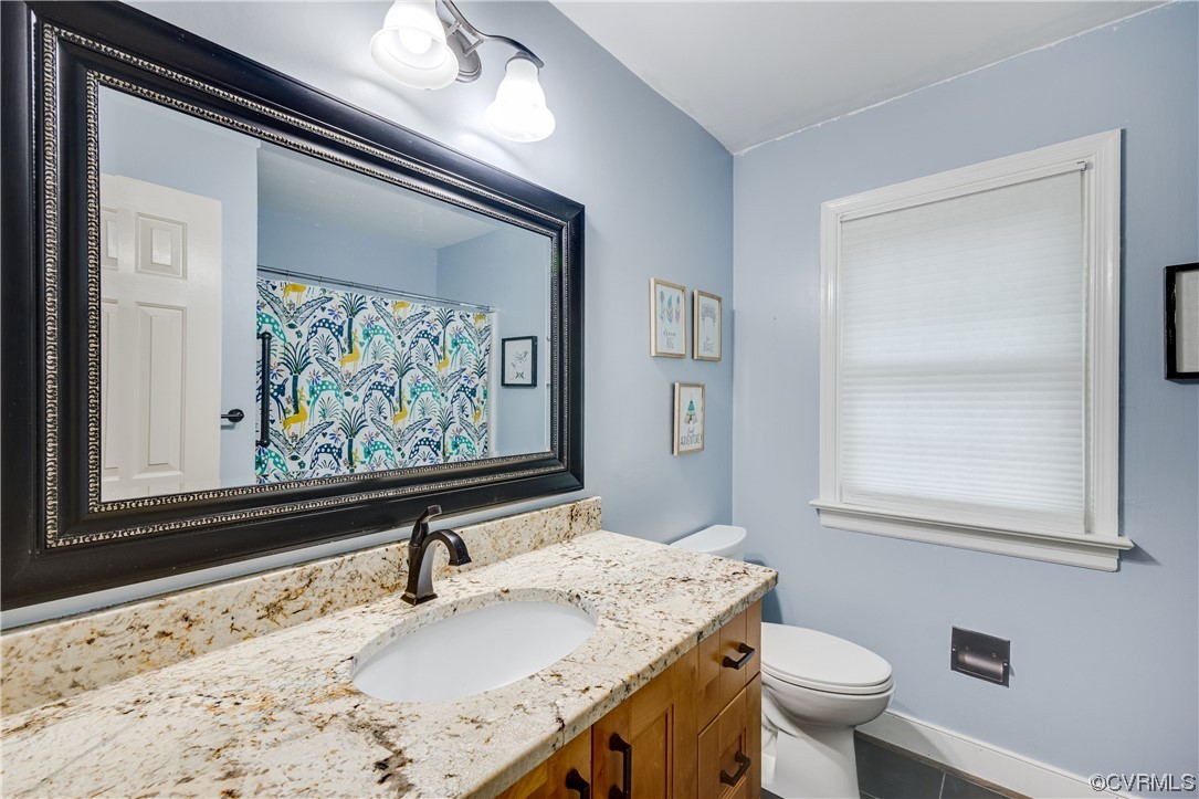 1424 Shirlton Road Midlothian, VA 23114 - Photo 30 of 42 a bathroom with a sink a toilet and a mirror