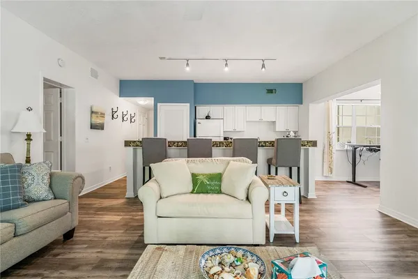 a living room with furniture and wooden floor