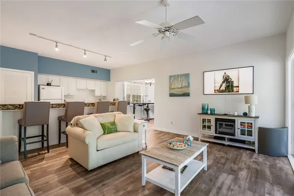 a living room with furniture and a wooden floor