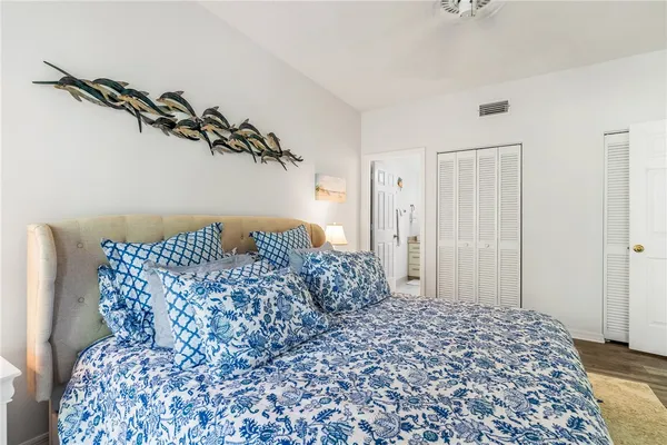 a large bed sitting in a bedroom next to a bathroom