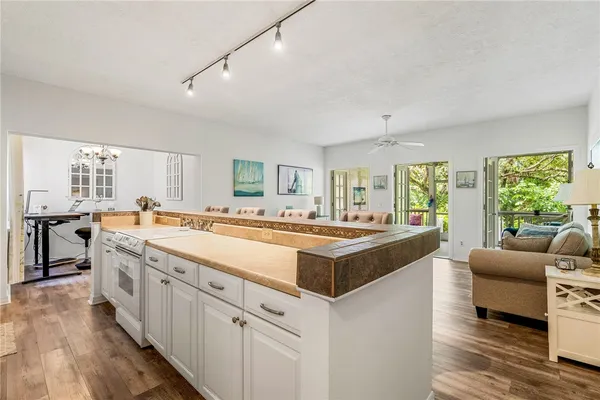 a large white kitchen with a large window