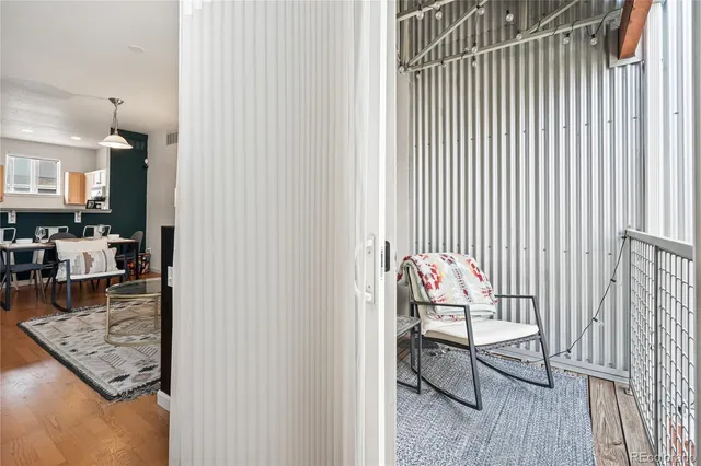 a view of a hallway with a couch and dining table