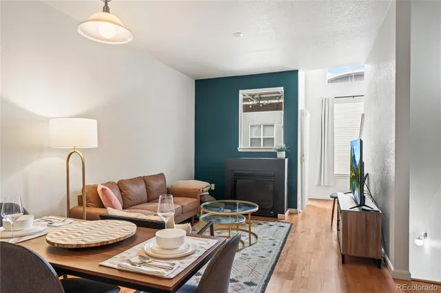 a living room with furniture fireplace and wooden floor