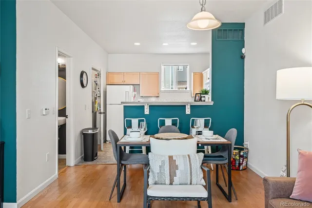 a dining room with furniture and a chandelier