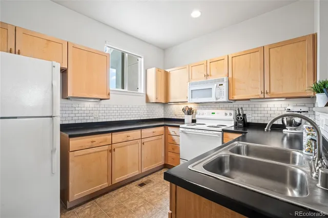 a kitchen with a sink cabinets and a refrigerator
