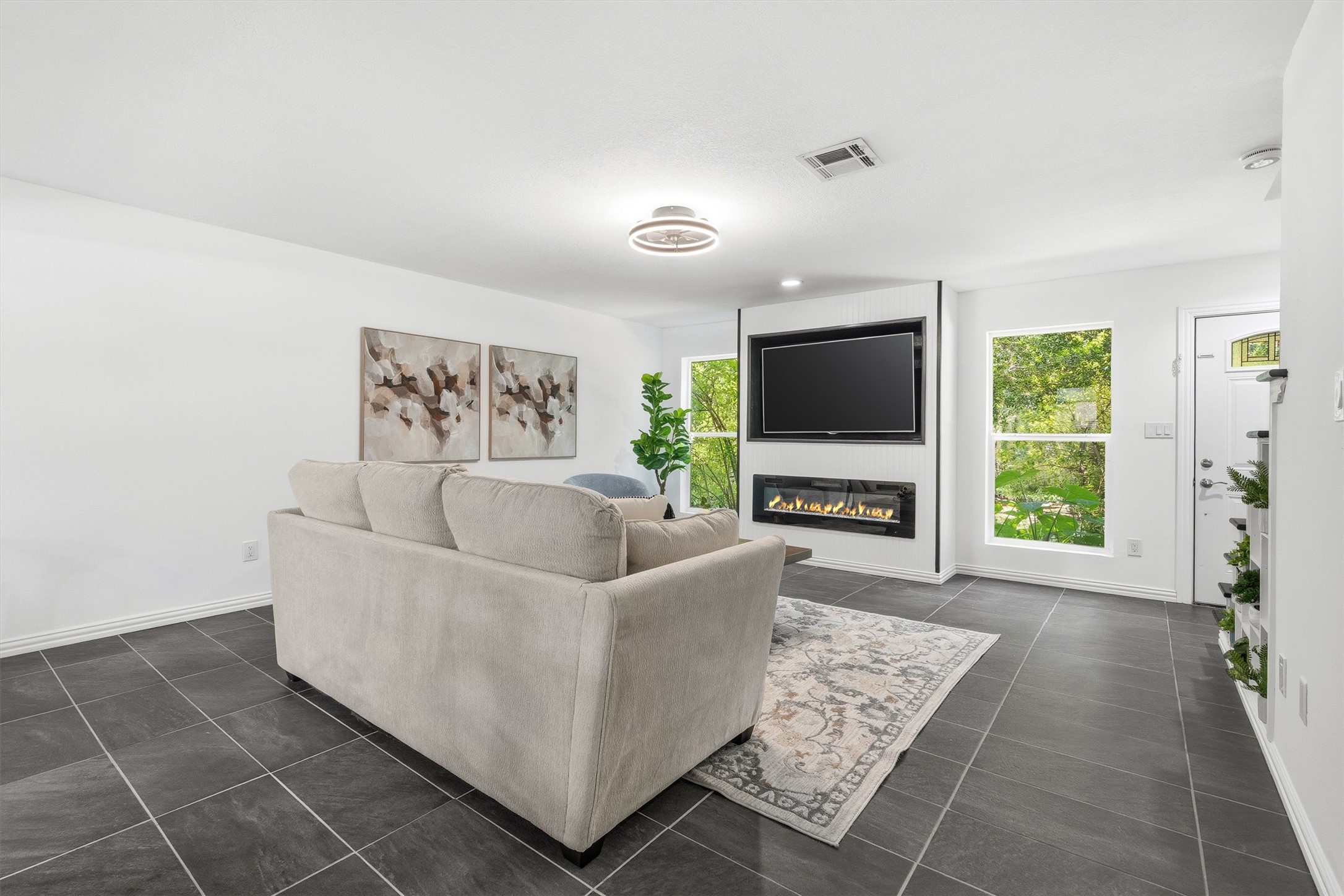 1011 Hamblen Road, Unit 306 Houston, TX 77339 - Photo 6 of 38 Natural light pours in from both sides, framing a fireplace built right into the living room wall, made for lazy Sunday mornings or a movie marathon with the shades wide open.