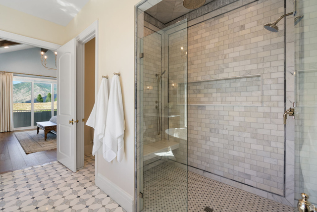 115 East Hidden Ridge Lane, Unit 42 Mapleton, UT 84664 - Photo 25 of 103 Glass-enclosed shower featuring subway tile walls, a built-in niche, and a corner bench