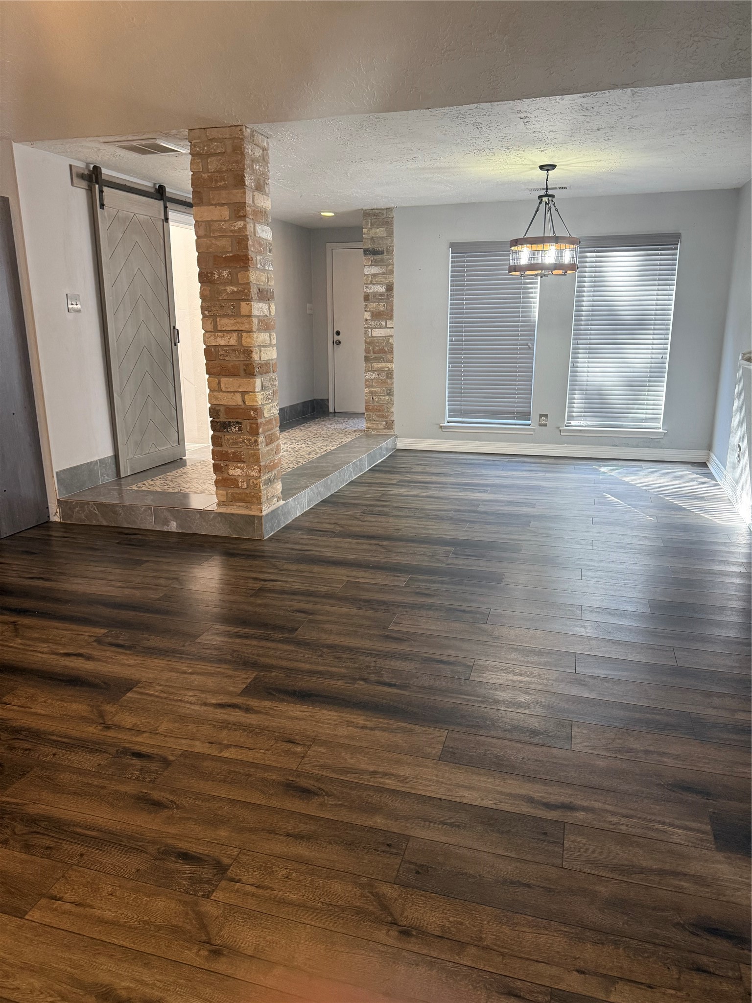 4642 Deer Point Drive Spring, TX 77389 - Photo 3 of 13 As you enter the front door, to the right is the office area behind a farmdoor, to the left it opens up to the formal dining and to the livingroom. This space offers newer laminate flooring with newer lighting.