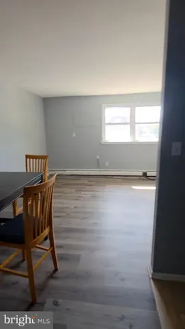 a view of a livingroom with wooden floor and a window