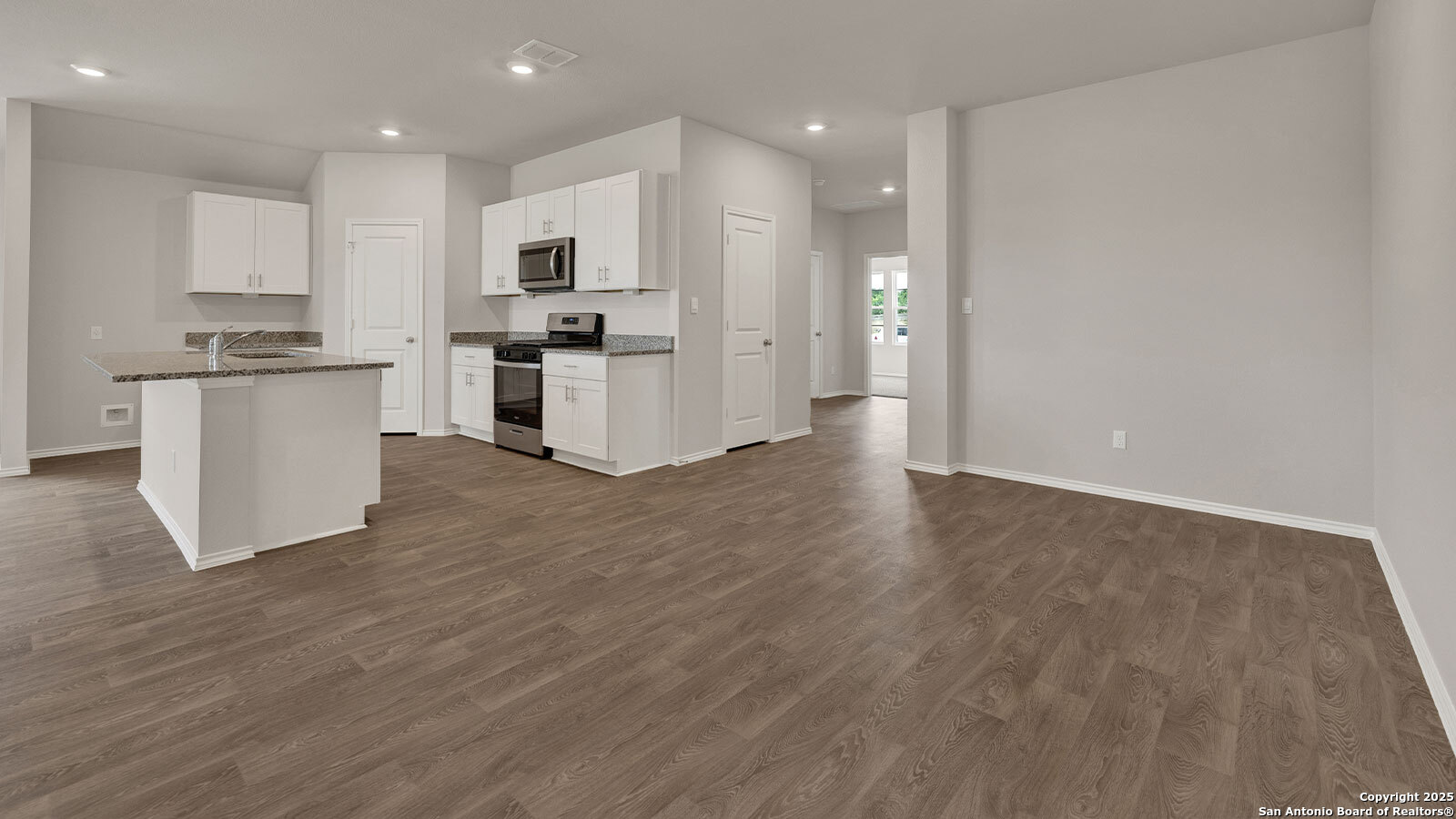 322 Hodges Street Maxwell, TX 78656 - Photo 12 of 34 a kitchen with white cabinets and stainless steel appliances