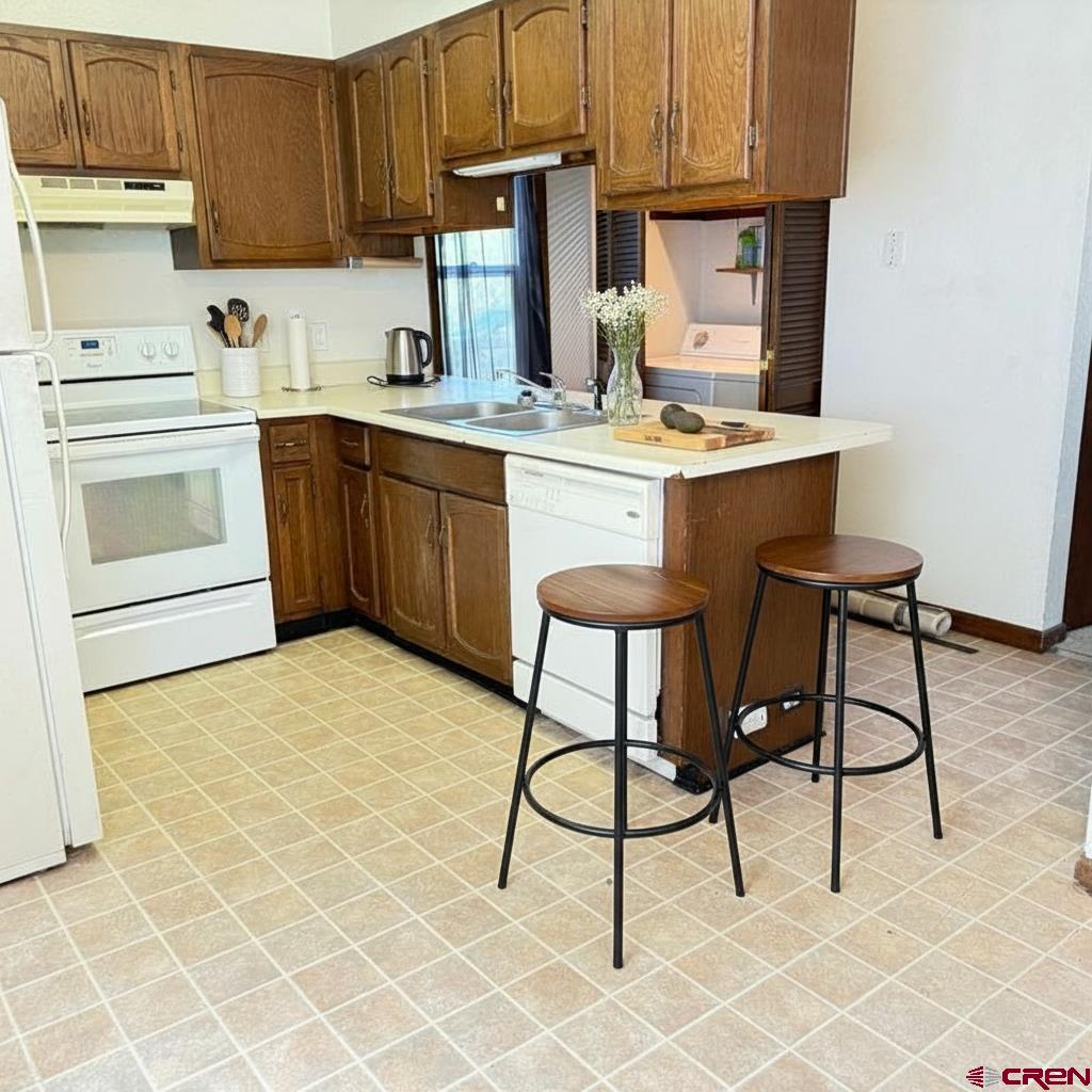 1021 West Denver Avenue, Unit 4 Gunnison, CO 81230 - Photo 1 of 26 a kitchen with a sink cabinets and window