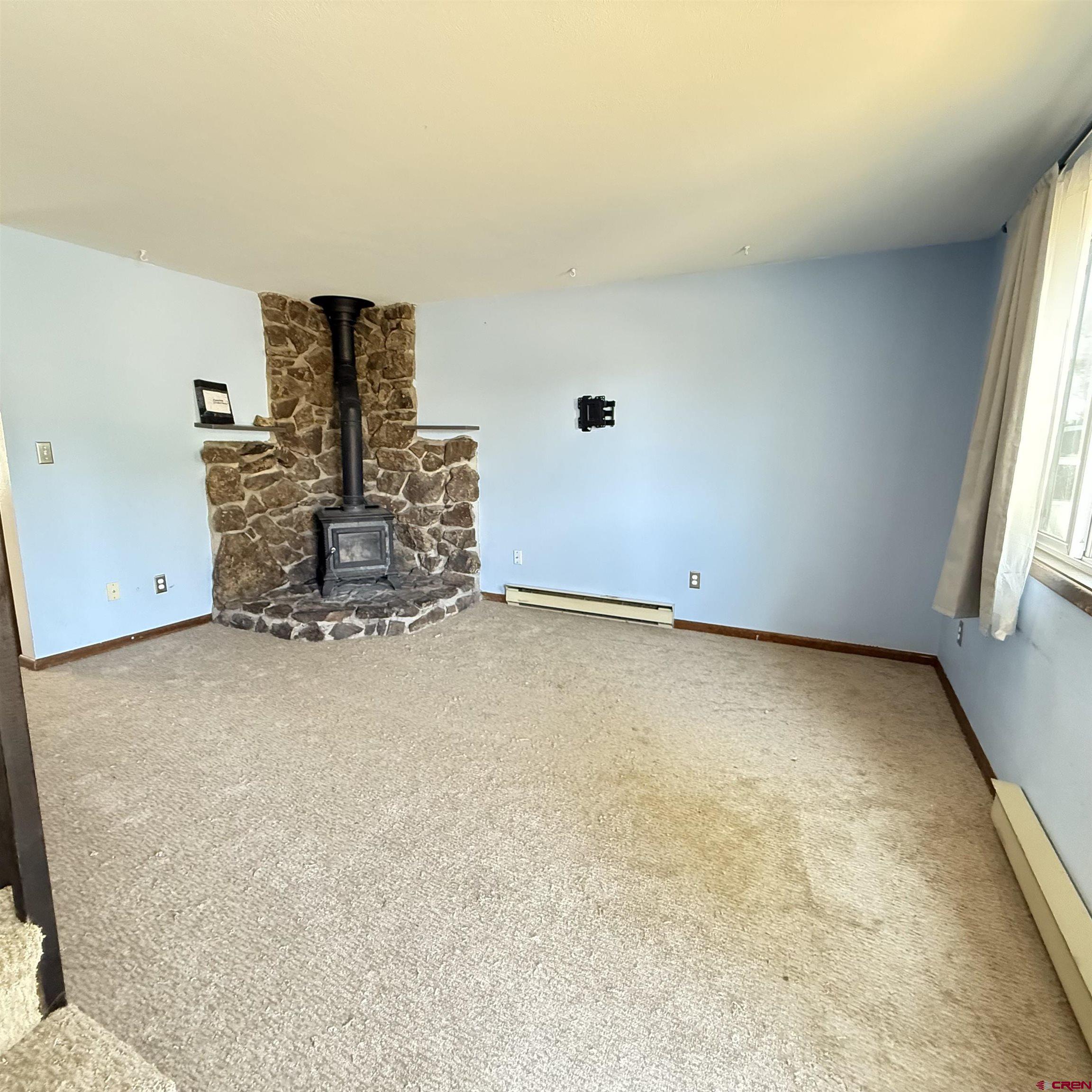 1021 West Denver Avenue, Unit 4 Gunnison, CO 81230 - Photo 11 of 26 an empty room with a empty space and windows