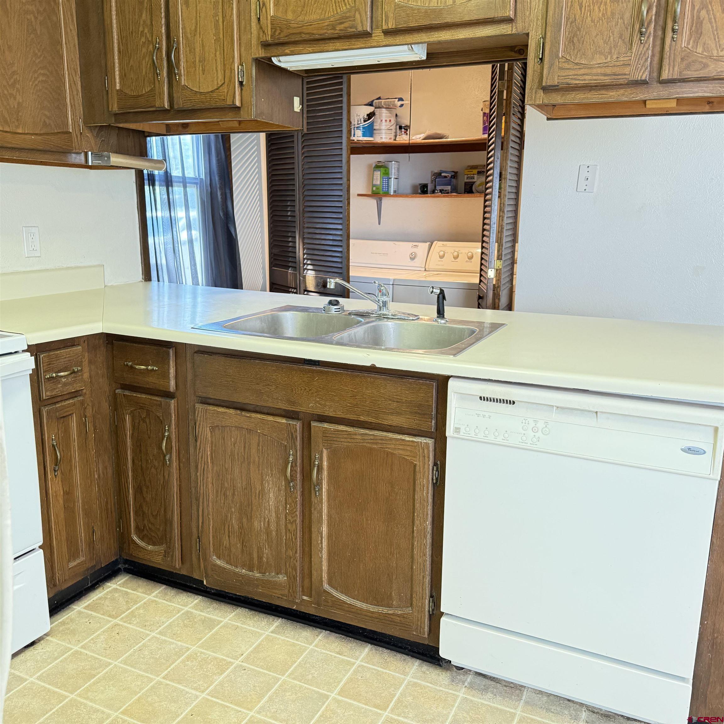 1021 West Denver Avenue, Unit 4 Gunnison, CO 81230 - Photo 14 of 26 a kitchen with granite countertop cabinets and window